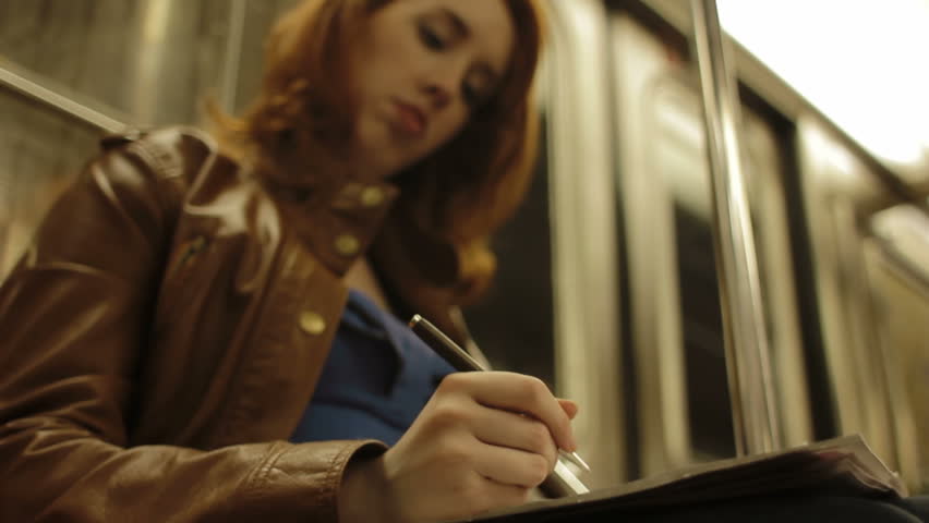 woman writing on train